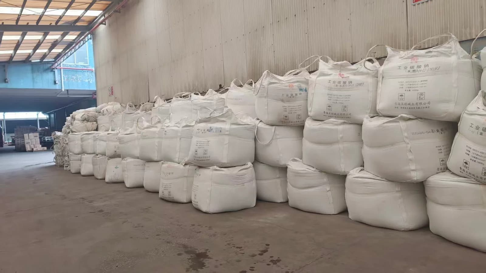 Bags labeled sodium carbonate (soda ash), one of the materials used in glassmaking.